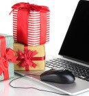 Laptop, gifts and computer mouse isolated on white
